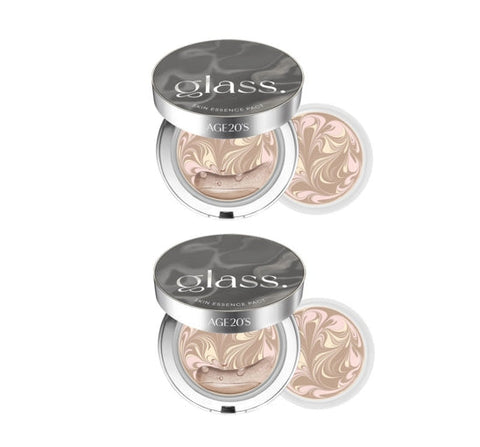 Two glass essence paks with marbled design on a white background