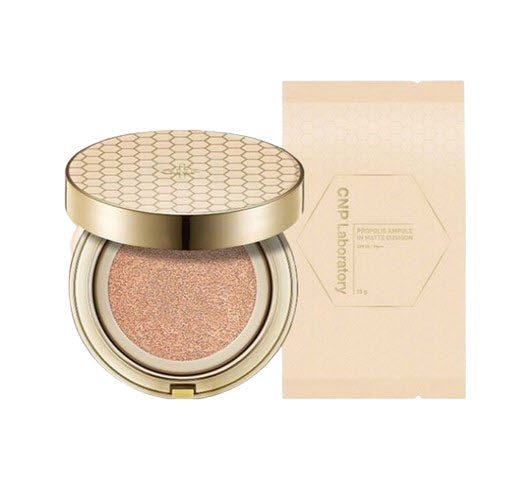 Cosmetic compact with gold lid and beige case on a white background