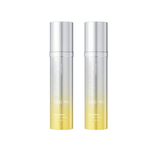 Two silver and yellow skincare bottles on a white background