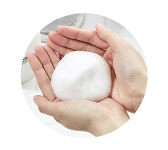 White snowball held in two hands against a white background