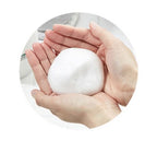 White snowball held in two hands against a white background